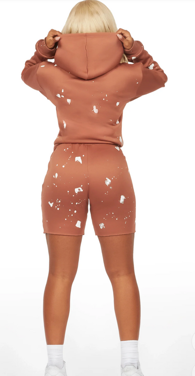 two-piece matching set features a cozy pullover hoodie and fitted biker shorts